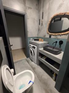 a bathroom with a sink and a washing machine at Mimis Skyline in Xanthi +17 photos