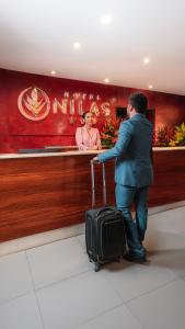 a man with a suitcase in front of a counter at Hotel Nilas in Tarapoto +116 photos