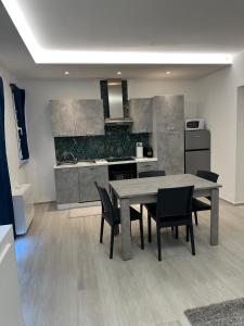a kitchen with a table and chairs in a room at Appartamenti Cataleya in Cuccurano
