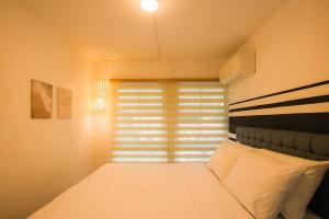 Фотография из галереи Casa - The Calm Coastal Two-Bedroom Suite Near SM Seaside Mall and Nustar Casino в Себу