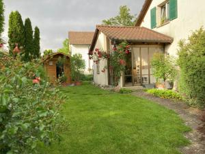 a house with a yard with green grass and flowers at Goldiger Berg - Pilatusweg 6 in Affoltern