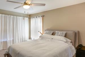 a bedroom with a bed with a ceiling fan and a window at PMC Mountainside Cabin Hit the Trails, Play Pool! in Pine Mountain Club