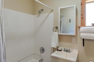 a white bathroom with a sink and a mirror at PMC Mountainside Cabin Hit the Trails, Play Pool! in Pine Mountain Club +19 photos