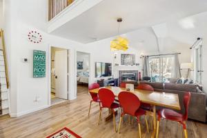 a dining room and living room with a table and chairs at The Woods Village 1 in Killington