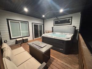 a room with a large tub in a house at Brand New Cabin with Fire Pit & Outdoor Projector in Duck Creek Village