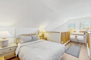 a bedroom with a bed and a desk and a table at The Woods Village 1 in Killington +33 photos