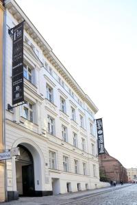 a large white building on the side of a street at Fortune boutique old town in Poznań