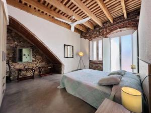een slaapkamer met een bed en een stenen muur bij Can Sala CostaBravaSi in Santa Cristina d'Aro +32 foto's