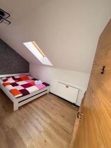 a small bedroom with a bed in a attic at Szekely Apartman in Ciumani +5 photos