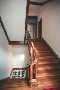 a staircase in a house with a wooden railing at Fortune boutique old town in Poznań