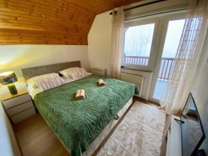 a bedroom with a bed and a large window at Cavljak Retreat, Sarajevo in Barice