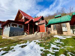 a house with snow in front of it at Cavljak Retreat, Sarajevo in Barice