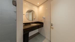 a bathroom with a sink and a mirror at St Charbel by Charlie in São Paulo +41 photos