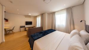 a hotel room with a bed and a couch at St Charbel by Charlie in São Paulo