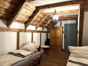 a room with two beds and wooden ceilings at Leśny Sentyment na Gwizdówce na Kaszubach in Załakowo