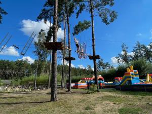 a playground with a bunch of colorful slides at Leśny Sentyment na Gwizdówce na Kaszubach in Załakowo