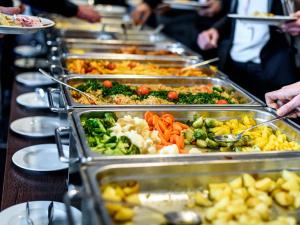 a buffet line of trays of food on a table at Mirtala Hotel Boutique in Guanajuato
