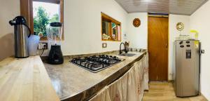 Cabaña Guanara في Vergara: مطبخ مع موقد وطاولة عمل