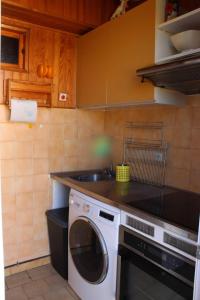 a kitchen with a washing machine and a sink at Chez David in La Celle-sous-Gouzon