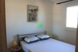 a bedroom with a bed with two pillows on it at Chez David in La Celle-sous-Gouzon