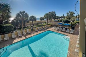 Relaxing Oceanfront Condo - Holiday Pavilion 211 في ميرتل بيتش: مسبح وكراسي صالة ومنتجع