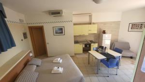 Residence Rosemary في برنزوني سول جاردا: شقة صغيرة فيها طاولة ومطبخ