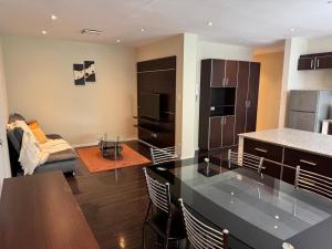 a kitchen and living room with a table and a counter top at 7th floor Live, Laugh and Relax in Cochabamba