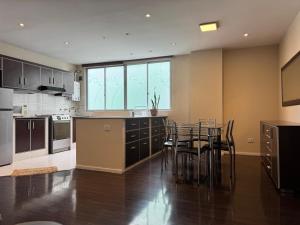 a kitchen with a table and chairs in it at 7th floor Live, Laugh and Relax in Cochabamba
