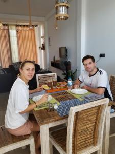 a man and a woman sitting at a table at J's lodge in Negombo