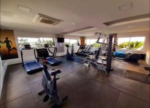 a gym with several treadmills and elliptical machines at Lindo Studio No Coração da Cidade e Prox ao Aeroporto in Guarulhos