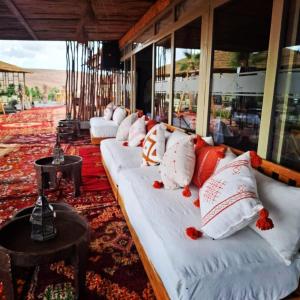 Aït MazouAgafay Yes We Camp Luxury Lodge Restaurant & Spa的带窗户的房间里有一排白色沙发
