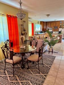 a living room with a table and chairs at Lynette's Palace in Port-of-Spain