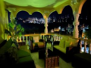 a living room with a couch and chairs and a city at Lynette's Palace in Port-of-Spain