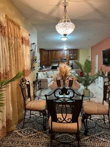 a dining room with a table and chairs at Lynette's Palace in Port-of-Spain