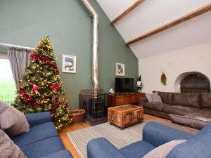 a living room with a christmas tree and a couch at 5 Bed in Botwnnog 55385 in Bottwnog
