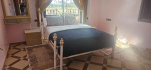 a bedroom with a bed in a room with a window at Atlas stay in Fez