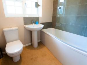 a bathroom with a toilet and a sink and a bath tub at 3 Bed in Brancaster Staithe oc-kt150 in Brancaster +19 photos