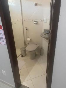 a small bathroom with a toilet and a sink at Pousada Cantinho da Jú in Pirenópolis +23 photos