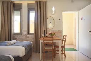 a bedroom with a table and a bed and a dining room at Melony Tsfat in Safed