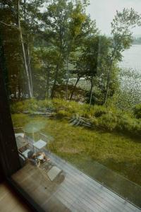 a dog laying on a deck looking out of a window at Shatemuc, a magical getaway on the Hudson River in Kingston