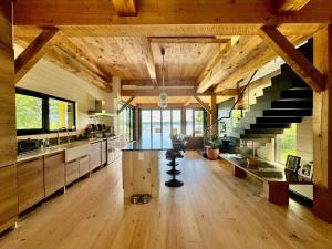 a large kitchen with a staircase in a house at Shatemuc, a magical getaway on the Hudson River in Kingston