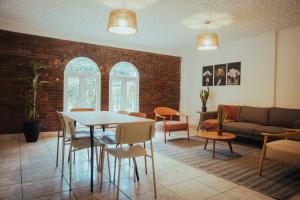 a living room with a table and chairs at Central Hostel Zona 4 in Guatemala