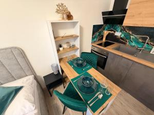une petite cuisine avec une table et un évier dans l'établissement SkyView Studio Vlčince with private parking, à Žilina 11 autres photos