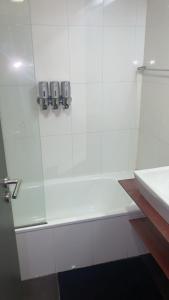 een witte badkamer met douche en wastafel bij El rejunte , CABA in Buenos Aires