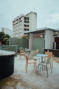 a group of tables and chairs on a rooftop at Central Hostel Zona 4 in Guatemala