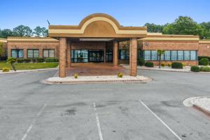 an empty parking lot in front of a building at Havelock Hotel in Havelock