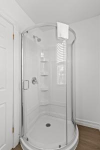 a shower with a glass enclosure in a bathroom at Relaxing 2BR Parking Self Check-In in Torbay