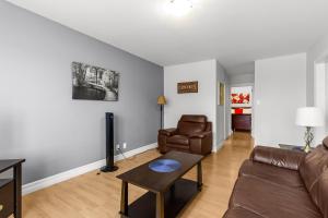a living room with a couch and a table at Relaxing 2BR Parking Self Check-In in Torbay