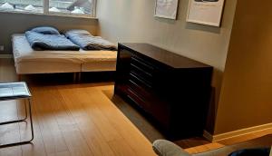 a room with a bed with blue pillows on it at Easy stay in Glostrup