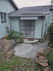 a house with a garage with a window at Royaltics place in Weltevredenpark